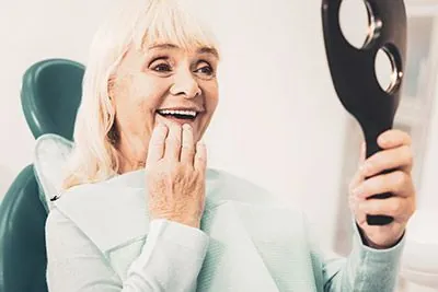 woman very happy with her dental implants she got from Rugby Dental Arts in Charlottesville, VA
