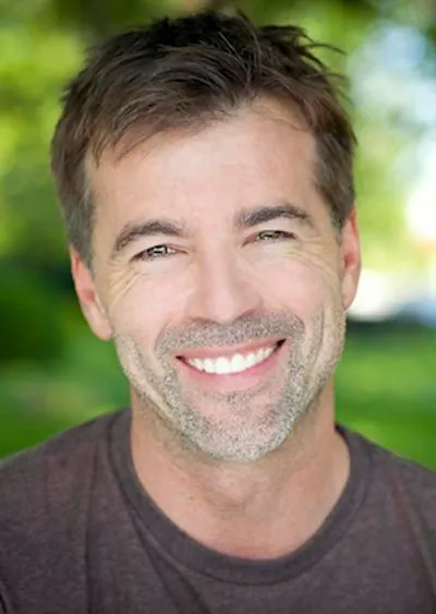 man showing off his freshly whitened smiles thanks to whitening services from Rugby Dental Arts in Charlottesville, VA
