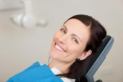 woman showing off her restored smile thanks to dental crowns from Rugby Dental Arts in Charlottesville, VA