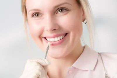 woman picking the color she would like for her dental veneers from Rugby Dental Arts in Charlottesville, VA