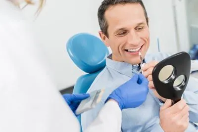 man picking out a color for his dental veneers before getting them from Rugby Dental Arts