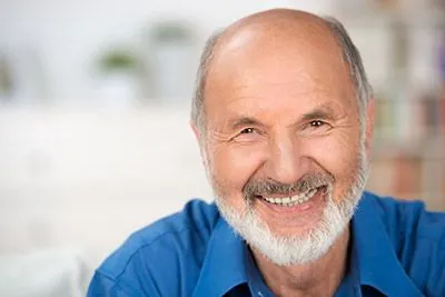 man smiling after tooth-colored filling helped restore his smile thanks to Rugby Dental Arts